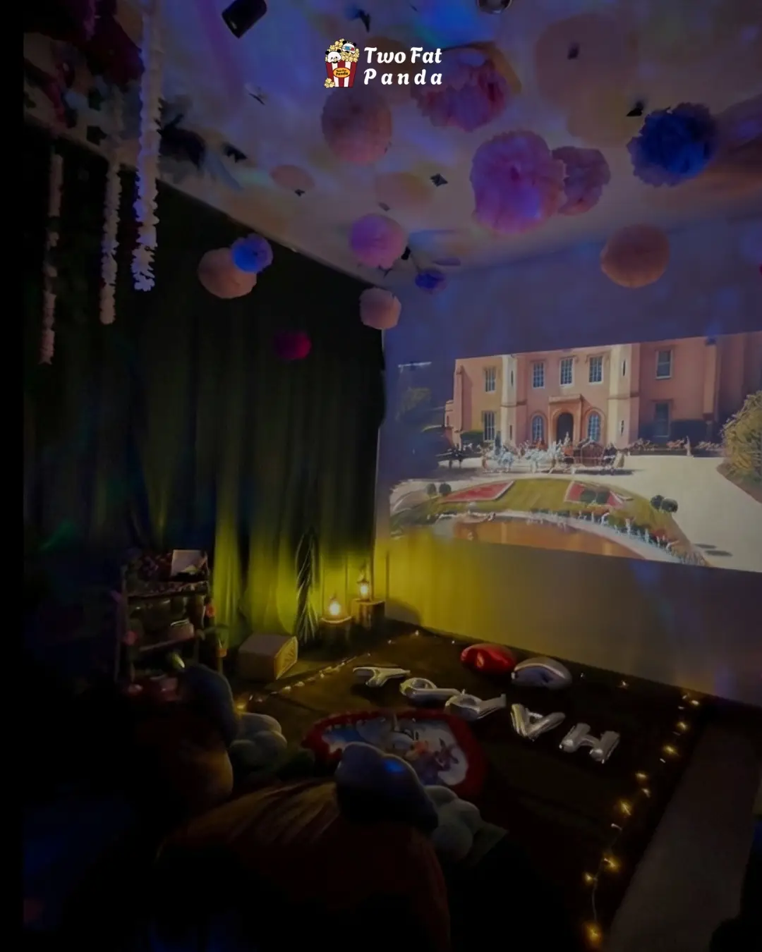 Two Fat Panda private cinema studio with a projected movie, soft lights, and a decorated ceiling